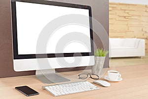 Desktop computer on work table showing white screen perspective
