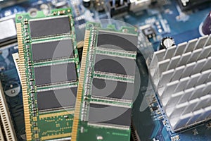 Desktop DDR RAM, against the background of a computer motherboard, closeup shot