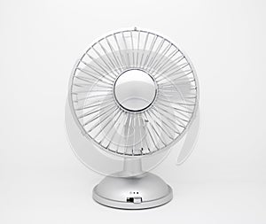 Desktop fan with spinning blades isolated on white background