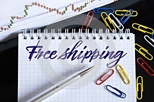 On the desktop are a forex chart, paper clips, a pen and a notebook in which it is written - Free shipping