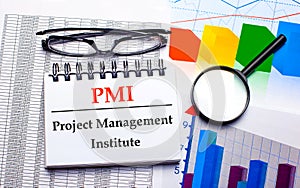 On the desktop are glasses, a magnifying glass, color charts and a white notebook with the text PMI Project Management Institute.