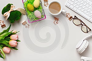 Desktop. Keyboard cup of coffee with easter spring decorations. Flat lay copy space top view