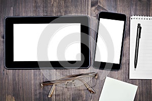 Desktop mix with notepad, pen and eyeglasses on a wood background