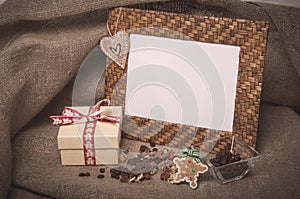 Desktop photo frame and coffee beans with gift box on linen