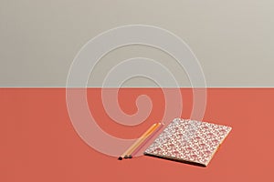 Desktop in vivid coral notebook with Renaissance pattern in live coral background