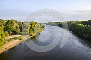 Desna river and green trees reflect in the water in Chernihiv, Ukraine