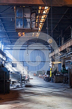 Desolate crane in an old valve factory hall