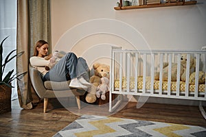 desolate young woman with soft toy