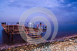 Desolated Dock On Sunset With Calm Sea