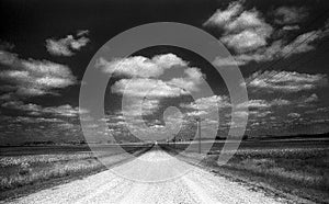 Desolated Gravel Road in the Country with Telephone Lines