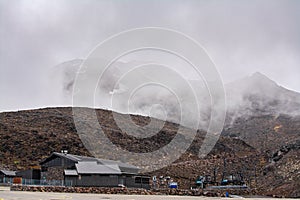 Desolated lava fields on the slopes of Mt Ruapehu. Out of season ski lifts disappearing in thick fog. Tongariro National