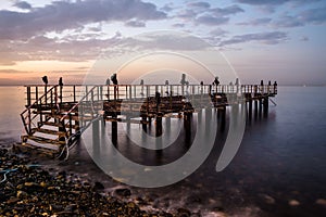 Desolated Dock On Sunset With Calm Sea