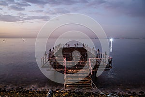 Desolated Dock On Sunset With Calm Sea