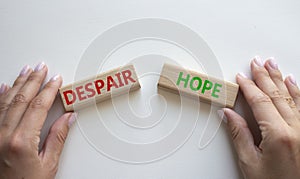 Despair or Hope symbol. Concept word Despair or Hope on wooden blocks. Businessman hand. Beautiful white background. Business and