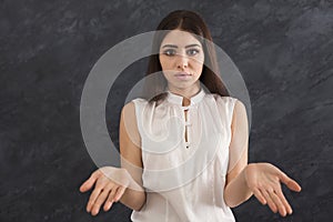 Desparate woman making helpless gesture with her hands