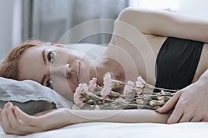 Desparing teenager with flower bouquet