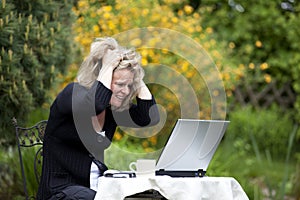 Desperate blond woman tearing her hair