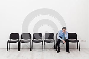 Desperate businessman or employee sitting alone