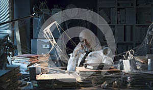 Desperate businessman sitting in his abandoned office