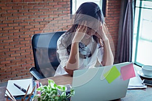 Desperate businesswoman worried in office, Asian woman headache