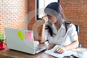 Desperate businesswoman worried in office, Asian woman headache