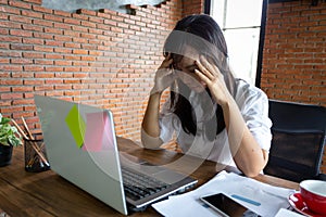 Desperate businesswoman worried in office, Asian woman headache