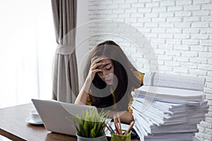 Desperate businesswoman worried in office, Asian woman headache