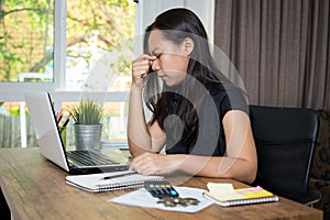 Desperate businesswoman worried in office, Asian woman headache