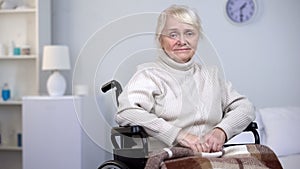 Desperate crying lady in wheelchair looking into camera, old age depression