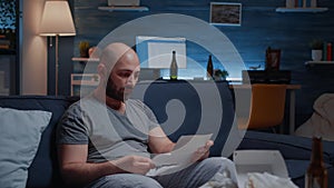 Desperate, depressed, helpless frustrated man reading banking bills