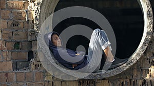 Desperate lonely male teen thinking of problem abandoned building, difficulties