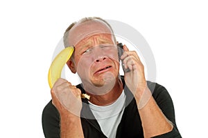 Desperate man phoning with banana gun