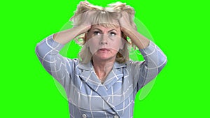 Desperate mature woman on green screen.