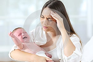 Desperate mother and her baby crying photo