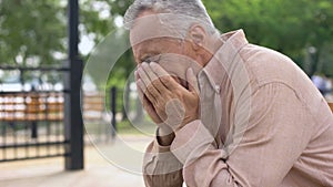 Desperate pensioner crying, depressed by sad memories, suffering loss, problem