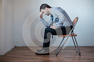 Desperate and pensive businessman seated