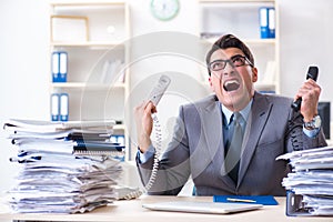 The desperate sad employee tired at his desk in call center