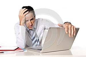 Desperate senior businessman in crisis working on computer at office in stress