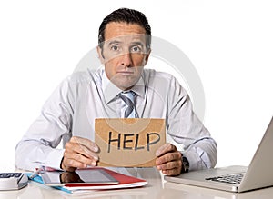 Desperate senior businessman in crisis working on computer at office in stress