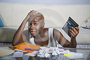 Desperate and stressed black afro American woman with calculator and paperwork banking in stress accounting business finance tax a