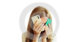 Desperate upset young woman holding mobile phone and bank card touching her head and covering face, internet fraud, problems with
