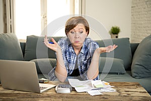 Desperate woman banking and accounting home monthly and credit card expenses with computer laptop doing paperwork