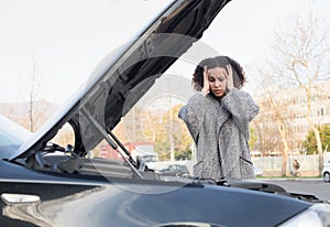 Desperate woman after checking car broken engine