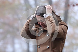 Desperate woman complaining alone in a park