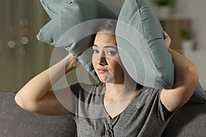 Desperate woman covering ears to protect from noise