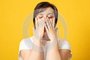 Desperate woman having depression hiding her crying face with hands
