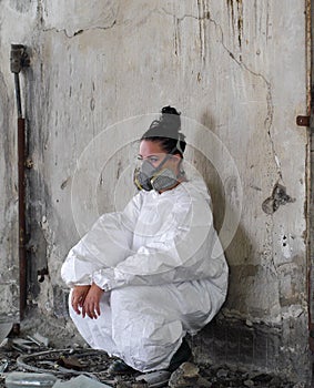 Desperate woman with mask in abandoned place