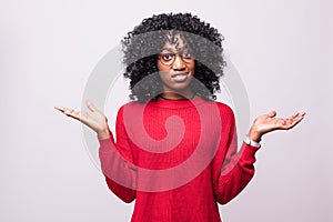 Desperate young african woman asking for help from above on white background