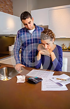 Desperate young couple with debts reviewing their