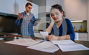 Desperate young couple with debts reviewing their bills